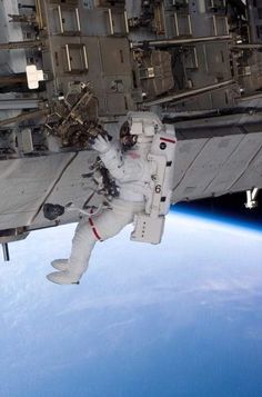 an astronaut floating in the air above earth