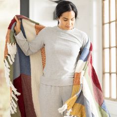 a woman holding a blanket in her hands