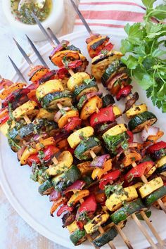 several skewers of vegetables on a plate with parsley