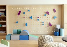 a child's playroom with toys and bookshelves