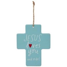 a blue cross ornament with the words jesus loves you and a red heart