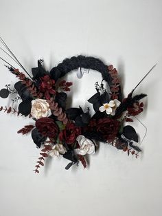 a wreath made out of flowers and feathers