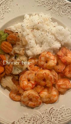 a white plate topped with rice and shrimp