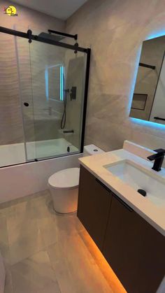 a bathroom with a sink, toilet and bathtub in it's center area