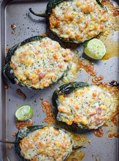 baked stuffed peppers with cheese and sauce on a baking sheet