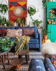 a living room filled with furniture and lots of plants