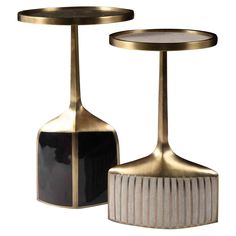 two black and white vases sitting next to each other on top of a table