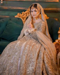 a woman in a wedding dress sitting on a couch