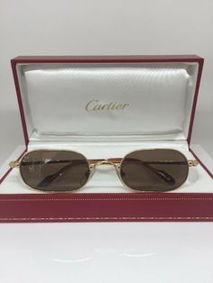 New Vintage Cartier Orfy Thin Rim Decor Trinity Sunglasses Eyeglasses Frame 18K Gold Plated 1990s A Rare Elegant Timeless pair of Vintage Rounded Rectangular Cartier Decor Trinity Sunglasses These sunglasses were crafted in the 1990's of 18-Karat Gold & Platinum Plated finish with resin temple tips for comfort. The temples are adorned with Cartier's distinctive C Decor. The Temple tips include a Gold-Plated metal Cartier signature plaque as well. The Cartier Orfy Vintage Sunglasses offer a uniqu Vintage Cartier Sunglasses, Gold Rimmed Sunglasses, Cartier Eyeglasses, Unique Glasses Frames, Cartier Glasses, Eye Accessories, Classy Glasses, Glasses Inspiration, Cartier Sunglasses