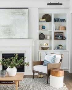 a living room with white walls and furniture