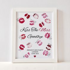 a white frame with lipstick kisses on it and the words kiss the miss goodbye written in red