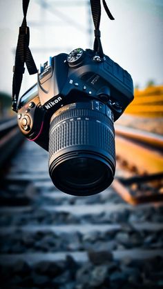 a camera is hanging from the ceiling next to railroad tracks