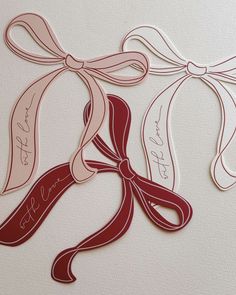 some paper cut out of ribbons with writing on them