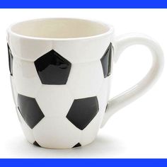 a black and white coffee cup with soccer balls on it