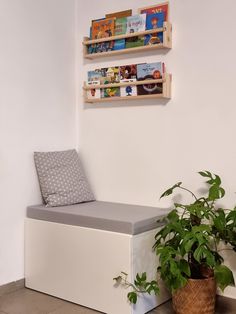 a white bench sitting next to a potted plant