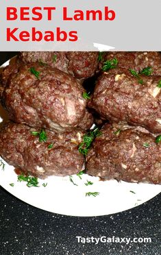 a white plate topped with meat patties covered in kebabs and garnished with parsley