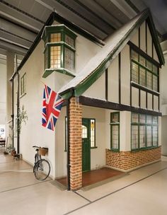 a house with a flag hanging from the roof and a bike parked in front of it