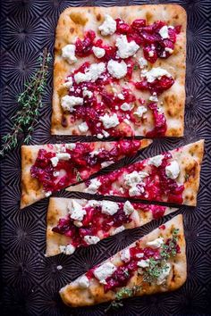 flatbread pizza with cranberry sauce and feta cheese on a black plate