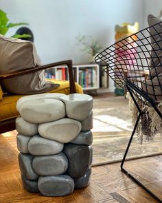 a stack of rocks sitting on top of a hard wood floor next to a chair