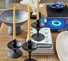 some candles are sitting on a table with books