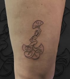 a woman's lower leg with a tattoo on it that has an umbrella in the middle