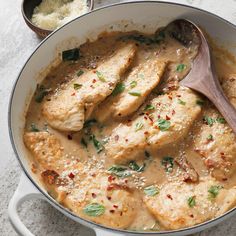 a pan filled with chicken covered in gravy and garnished with parsley