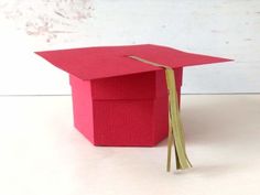 a red graduation cap sitting on top of a table