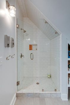 a walk in shower sitting inside of a bathroom