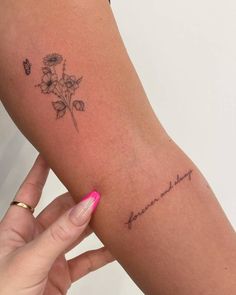 a woman's arm with a tattoo on it that says, love and flowers