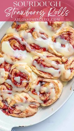 a white plate topped with strawberry rolls covered in icing