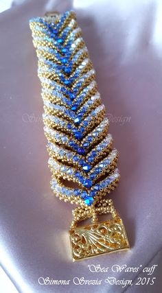 a gold bracelet with blue beads on it