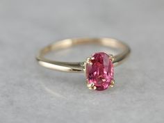 Truly all about the stone, this traditional, yellow gold mounting frames the stone perfectly while holding it securely with four split prongs. The center pops with an amazing pink color and is adorned with an expertly cut pink sapphire. Metal: 14K Yellow Gold Gem: Pink Sapphire 1.17 Carats Gem Measurements: 5 x 7.5 mm, Oval Ring Size: 5.75 Marks: "14" Stamped on the inside band Pink Ruby Ring With Accent Stones For Formal Occasions, Formal Pink Ruby Ring With Accent Stones, Classic Pink Ruby Ring With Brilliant Cut, Formal Pink Ruby Ring With Brilliant Cut, Formal Pink Brilliant Cut Ruby Ring, Pink Ruby Ring With Center Stone Fine Jewelry, Pink Ruby Rings With Prong Setting, Pink Ruby Rings With Brilliant Cut, Pink Formal Birthstone Ring