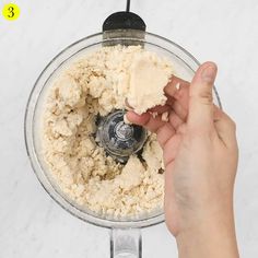 someone is mixing ingredients in a food processor