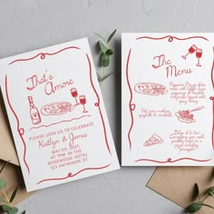 two cards with red ink on them sitting next to each other, one has a wine glass and the other has a pizza