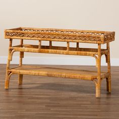 a bench made out of wicker sitting on top of a hard wood floor next to a wall