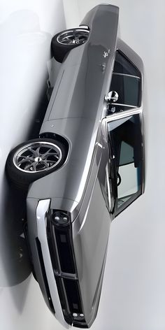 an overhead view of a silver truck with its hood up and the door ajar open