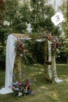 an outdoor wedding setup with flowers and greenery