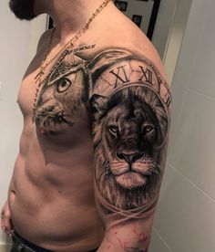 a man with a lion and clock tattoo on his arm is standing in front of a mirror