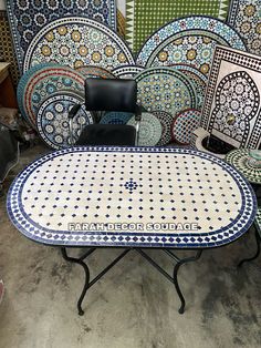 a table and chairs are sitting in front of colorful tile wall panels, with the words farah decor source written on it