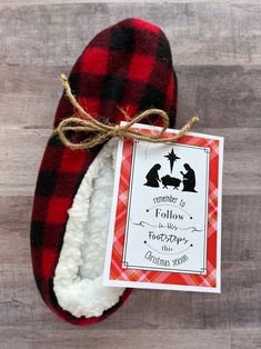 a red and black plaid slipper with a christmas tag hanging from it's side