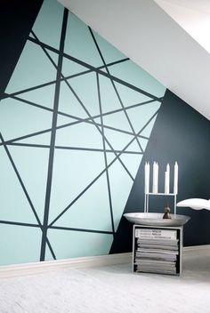 a living room with black and white wallpaper, candles and a table in front of it