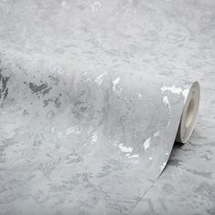 a roll of white marble paper on top of a table