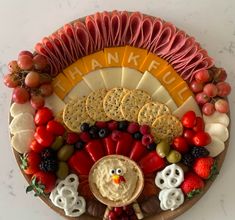 a turkey shaped platter with crackers and fruit