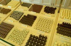 there are many different types of chocolates on display