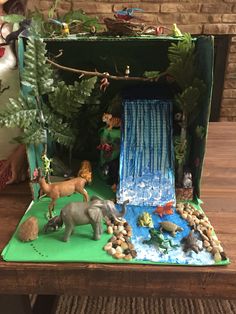 an open cardboard box filled with animals and plants