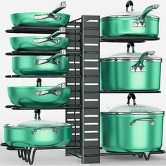 green pots and pans are stacked on shelves