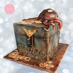 there is a cake that looks like an octopus on top of a trunk with gold decorations