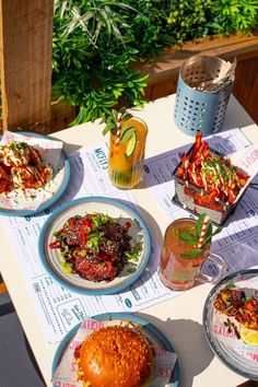 a table topped with plates of food and drinks