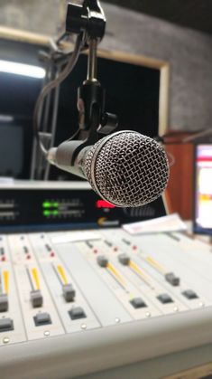 a microphone and sound board in a recording studio