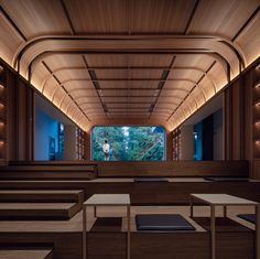 an empty room with benches and tables in it